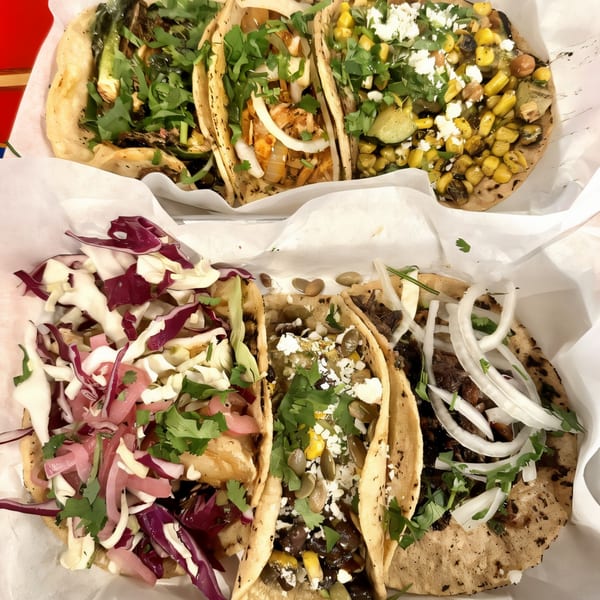 Six Str8 up Tacos with various fillings, including corn, onions, cilantro, and cabbage.